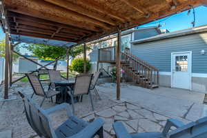 Fenced backyard with a patio and small deck