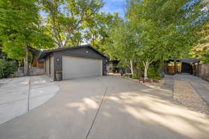 View of front of home featuring concrete driveway, brick siding, and an attached garage
