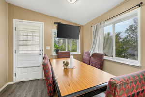 Dining room featuring lofted ceiling and wood finished floors