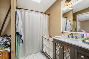 Bathroom with vanity and a skylight