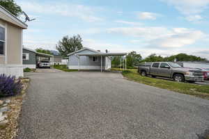 View of front of home featuring asphalt driveway and a residential view
