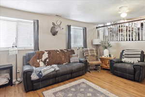 Living area featuring wood finished floors and a textured ceiling