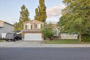 View of front facade with an attached garage and concrete driveway