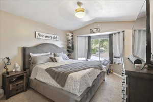 Bedroom featuring light carpet, lofted ceiling, cooling unit, ceiling fan, and baseboards