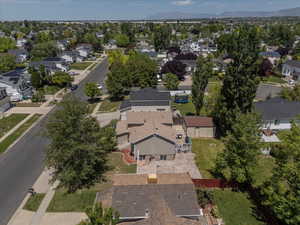 Aerial view of property and surrounding area with nearby suburban area