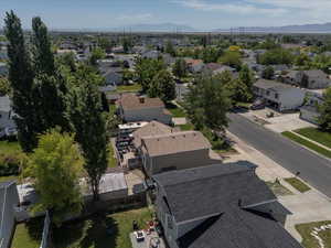 Aerial view of property's location featuring nearby suburban area and mountains