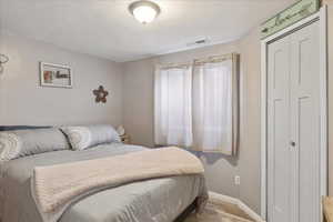 Bedroom featuring light wood-style floors and baseboards
