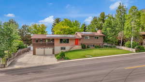 Split level home with solar panels and attached garage,