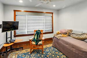 Bedroom featuring wood finished floors, baseboards, recessed lighting, and a ceiling fan