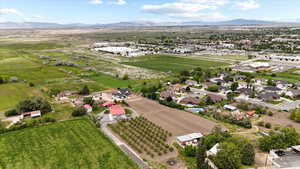 Aerial view of property and surrounding area featuring mountains and rural landscape