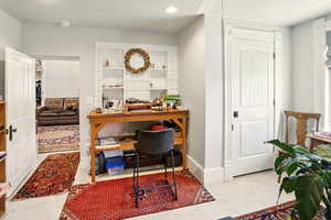 Office space with recessed lighting and baseboards