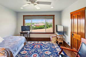 Bedroom with baseboards, recessed lighting, a ceiling fan, and wood finished floors