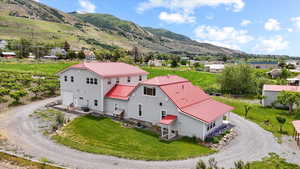 Aerial view of property and surrounding area with a mountainous background