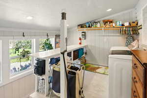 Laundry room with washer / dryer and a decorative wall