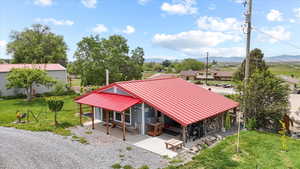 Aerial view of property and surrounding area featuring mountains