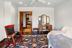 Bedroom featuring baseboards, wood finished floors, recessed lighting, and a ceiling fan