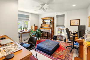 Carpeted office featuring ceiling fan and recessed lighting