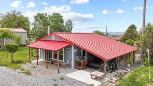 View of home's community featuring a patio, a lawn, and a mountain view