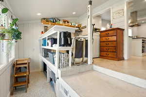 Bedroom with a decorative wall and recessed lighting