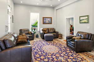 Living room with a ceiling fan and recessed lighting