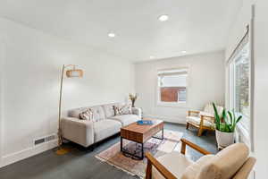 Living room with recessed lighting, baseboards, and painted hardwood floors