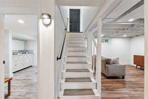 Back entry and staircase with wood finished floors