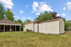 Large yard with patio, outbuilding, and spacious shed