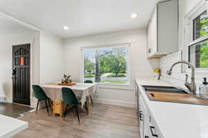 Eat-in kitchen with large window and space for table.