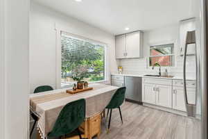 Newly renovated kitchen with stainless steel appliances, quartz countertops, and large window