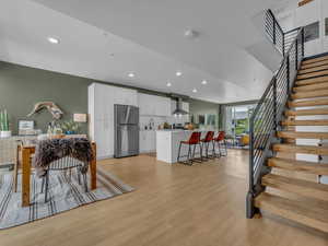 View from the entry - LVP flooring, industrial stairs that manage to feel homey, high ceilings