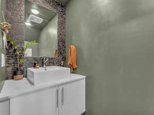 Bathroom with decorative backsplash and vanity