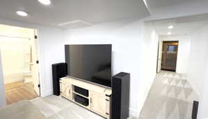 Hall with light carpet, baseboards, and recessed lighting