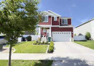 View of front of house with an attached garage, stairs, and concrete driveway