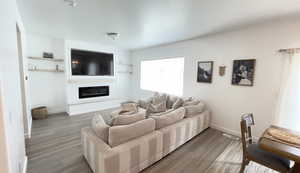 Living area with wood finished floors, baseboards, and a fireplace