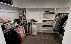 Walk in closet featuring carpet flooring