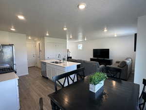 Dining area featuring dark wood-style floors, recessed lighting, and baseboards