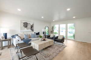 Living room featuring light wood finished floors and recessed lighting