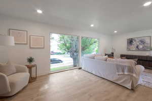 Living room with light wood-type flooring, recessed lighting, and baseboards