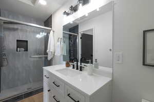 Bathroom featuring vanity and a stall shower