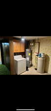 Finished below grade area with water heater, a water softener, and independent washer and dryer