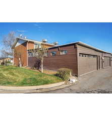 View of front facade with a front yard and a garage