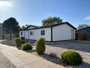 View of property exterior featuring crawl space and metal roof