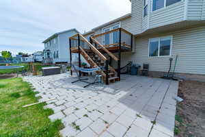 View of patio / terrace featuring a trampoline, stairway, and a deck