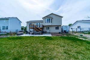 Back of house with a patio, stairs, and a new deck