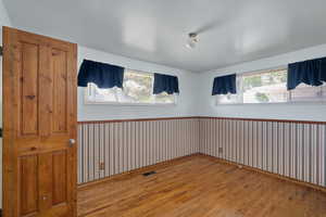 Unfurnished room with wood finished floors