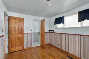 Empty room featuring wood finished floors