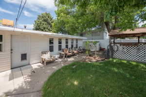 Back of property with a patio area and a lawn