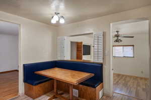 Unfurnished dining area with breakfast area, wood finished floors, and baseboards