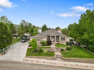 Ranch-style house featuring a carport, driveway, and brick siding