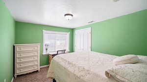 Carpeted bedroom featuring baseboards and a closet